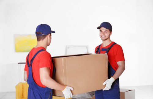 Professional movers packing items carefully