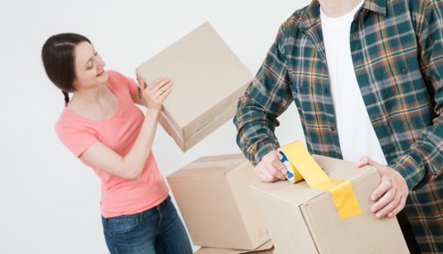 Happy customers after a successful move with a removal truck