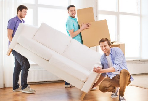 Professional crew loading items into a removal truck